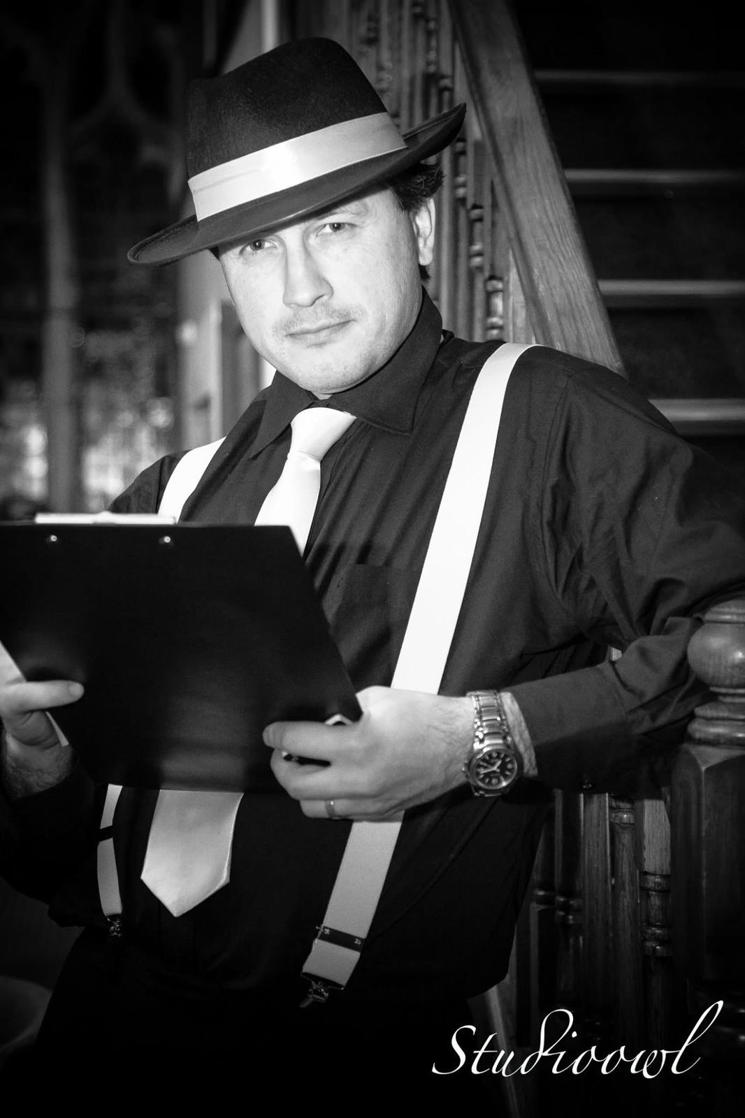 Mafia Romande host in black and white studio portrait